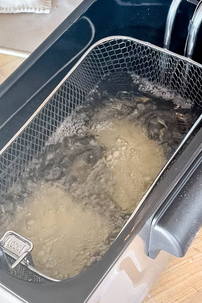 Pies submerged in the deep fryer. 