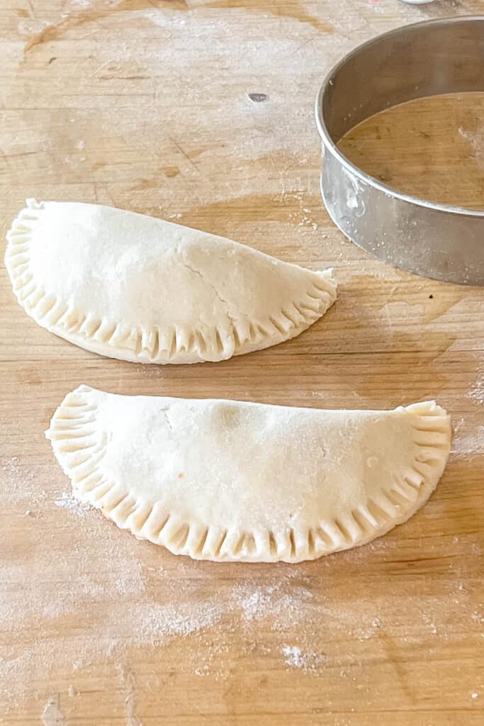 Folding pies in half and sealing.