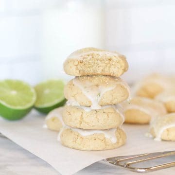 Four glazed key lime cookies on a wire rack.