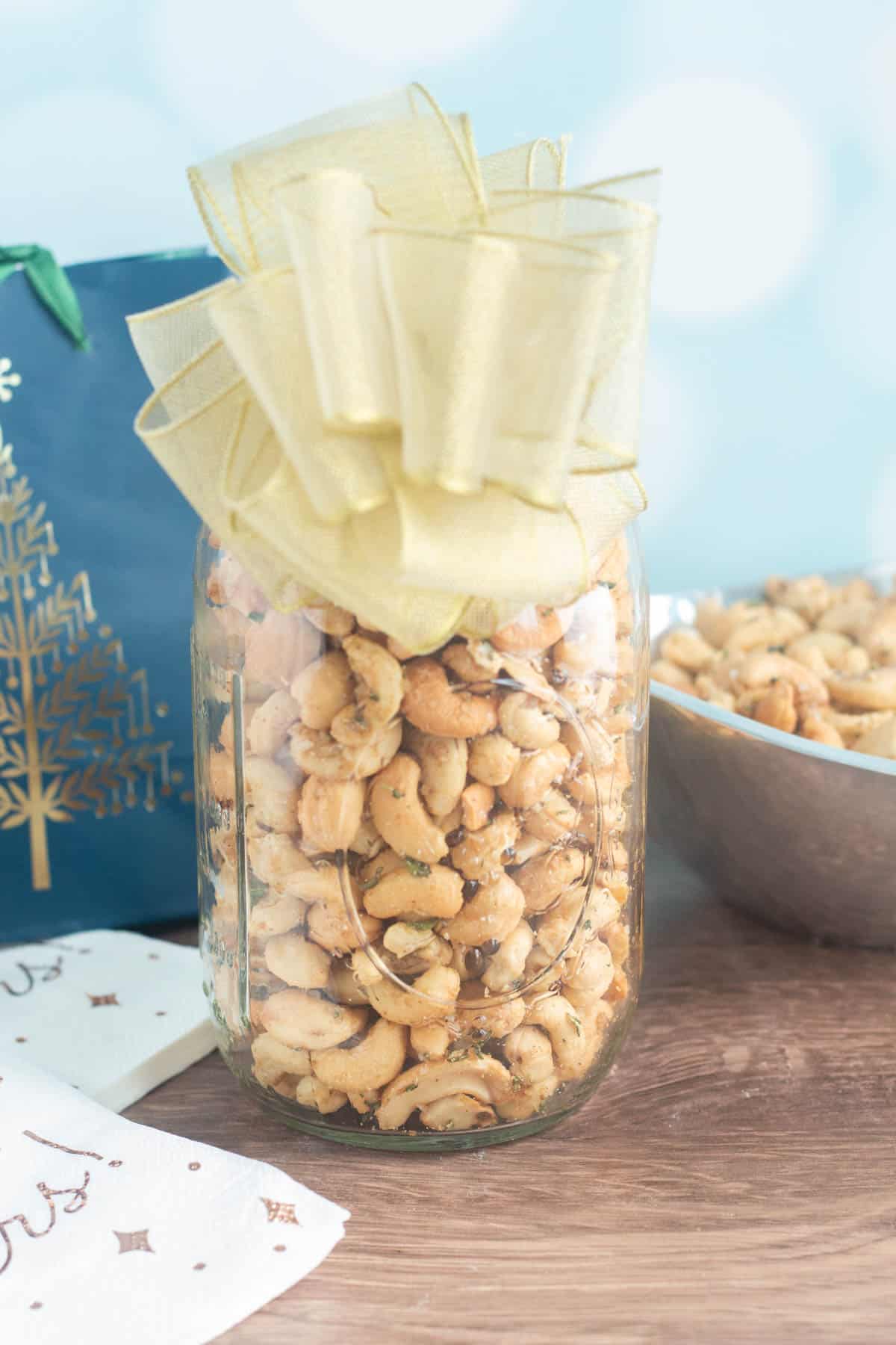 Rosemary roasted cashews in a gift mason jar with a bow. 