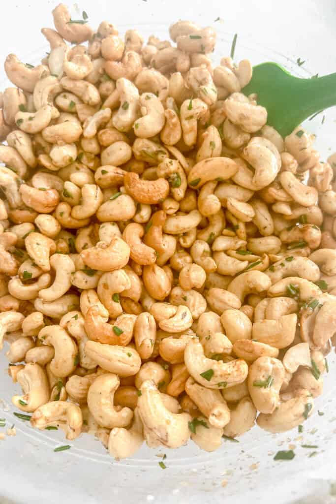 Cashews mixed with the seasoning mixture. 