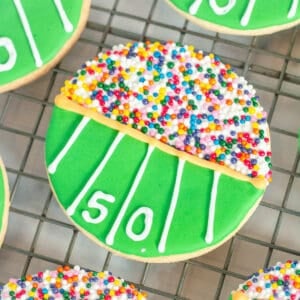 Decorated football cookies in a stadium theme.