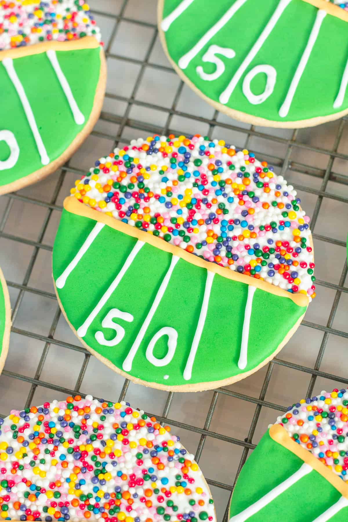 Colorful decorated football cookies with a stadium theme.