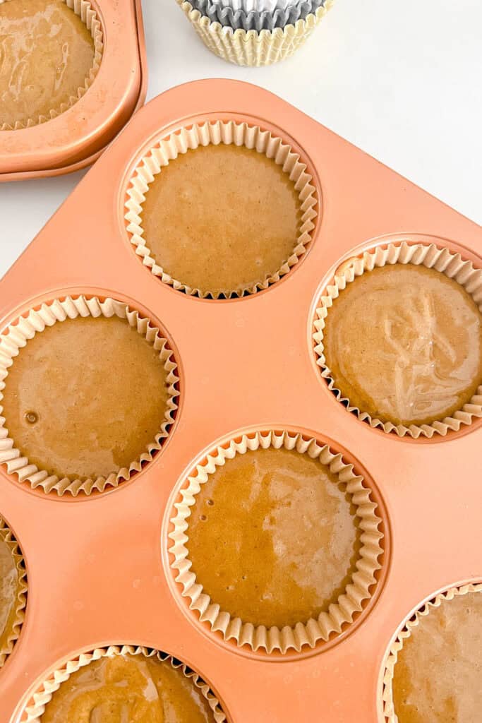 Cupcake batter divided among baking cups. 