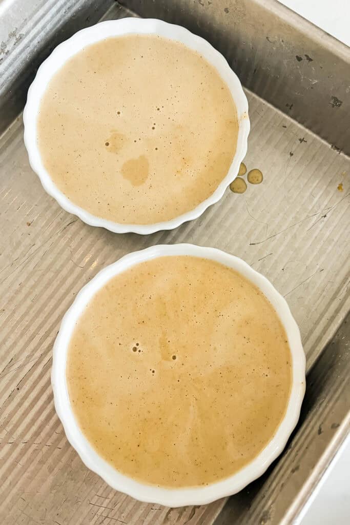 Filled ramekins on a baking sheet. 