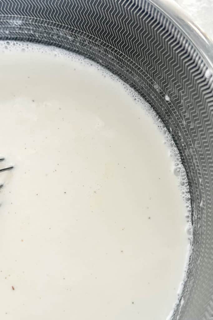 Bringing cream and half and half to a boil in a saucepan.