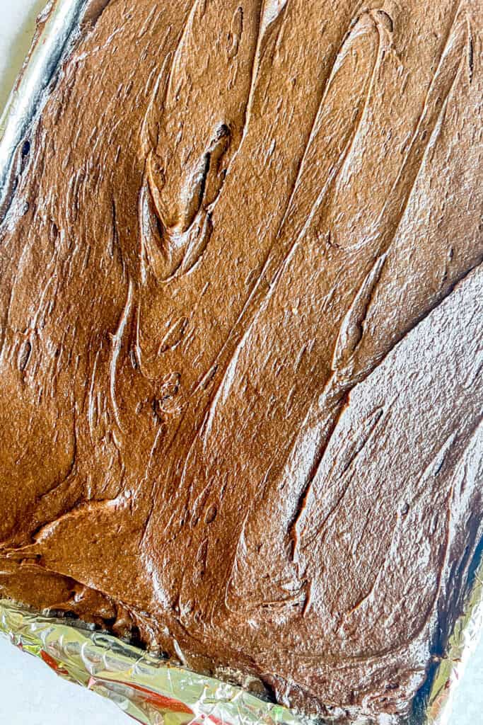 Brownie batter spread into the pan. 