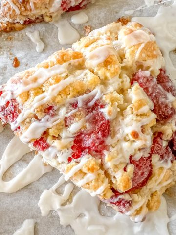 White Chocolate Raspberry Scones on parchment paper.