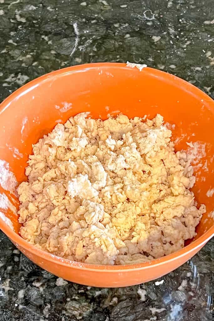 Cream added to cobbler dough in a bowl. 
