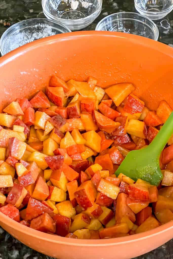 Fresh peaches mixed with other cobbler filling ingredients. 