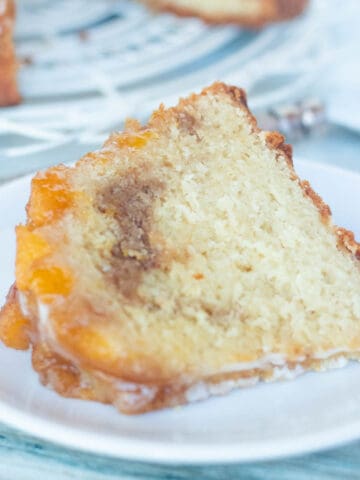Slice of Peach Cobbler Pound Cake on white plate.