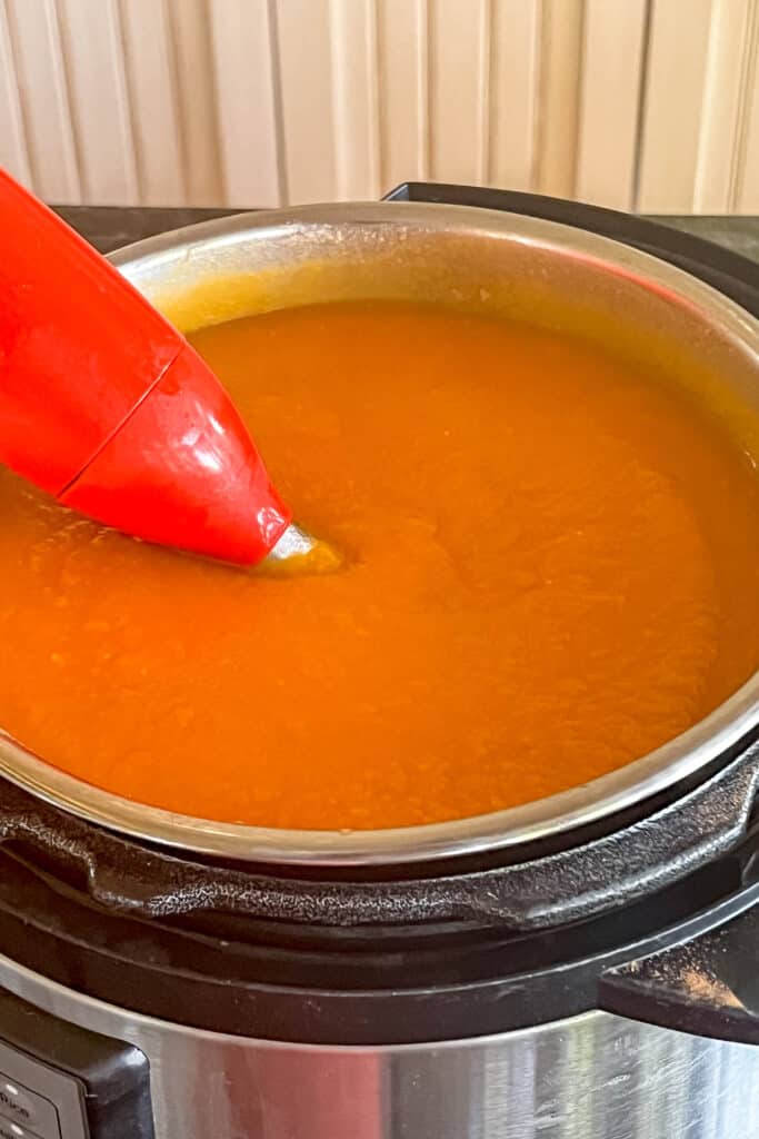 Butternut squash and sweet potato soup after being pureed with immersion blender. 