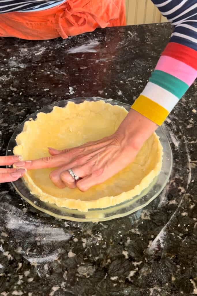 Crimp around the edge of the pie plate with your fingertips or a fork. 