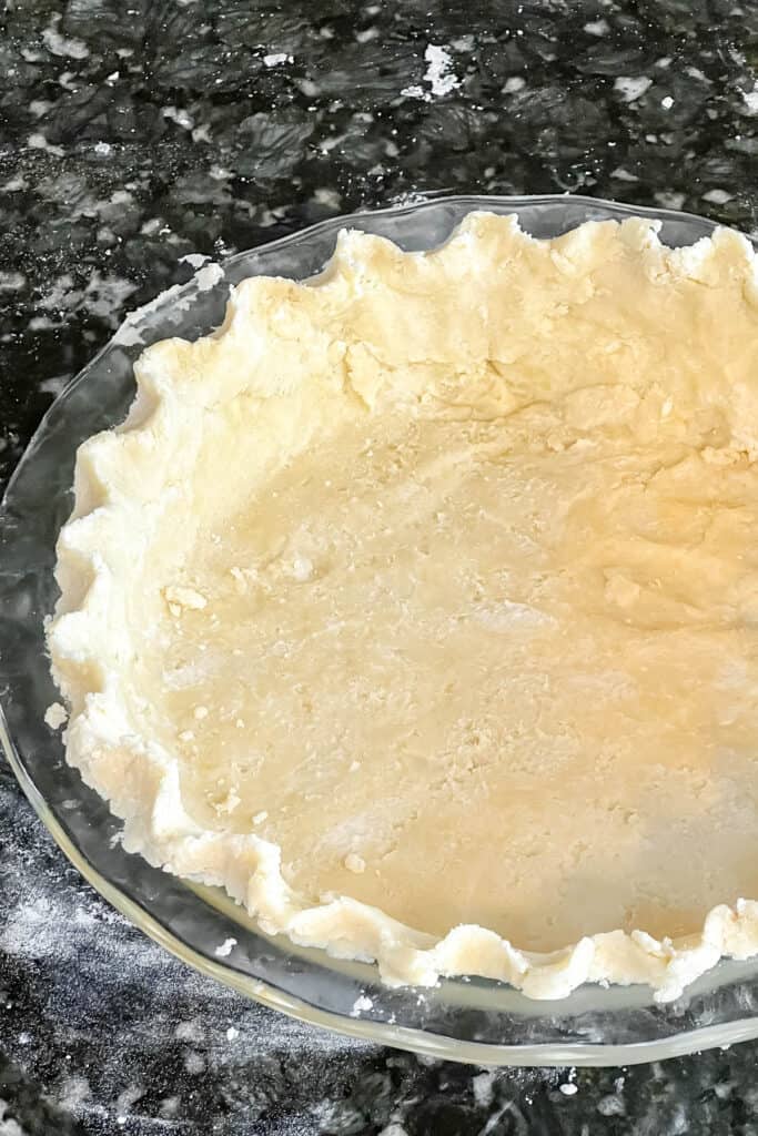 Finished pie crust in a pie plate. 
