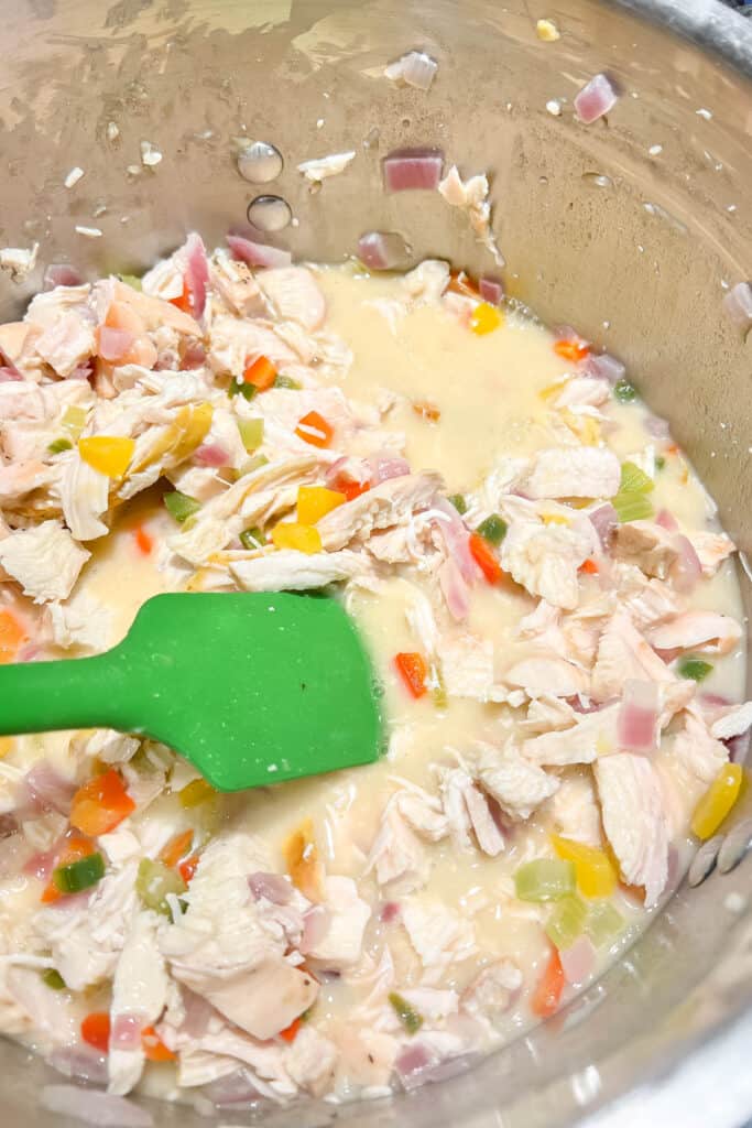 Adding chicken broth and simmering to thicken. 