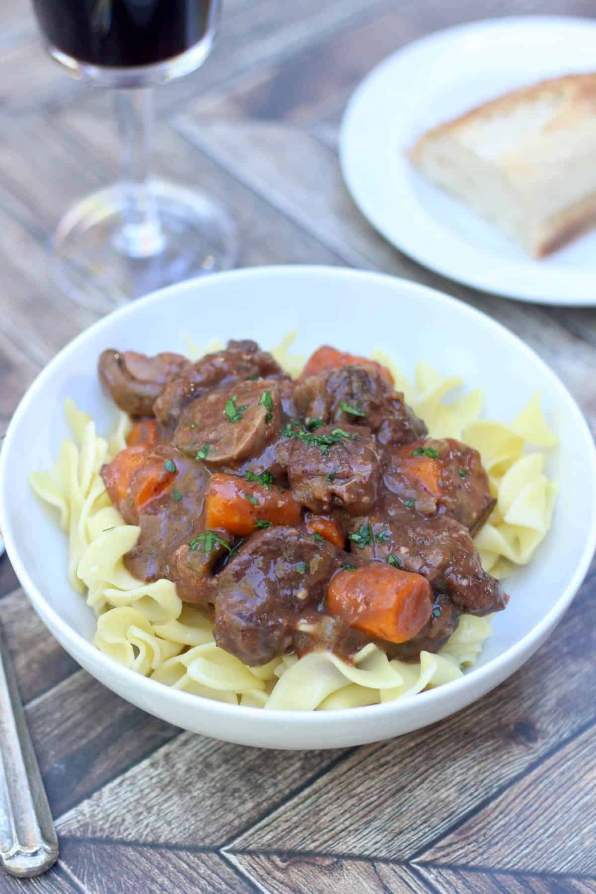 Beef bourguignon over buttered noodles. 