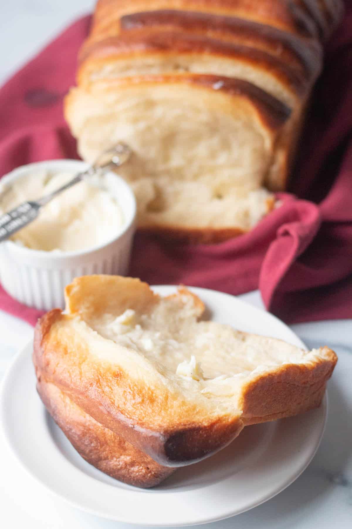 Slice of pull apart bread spread with butter. 