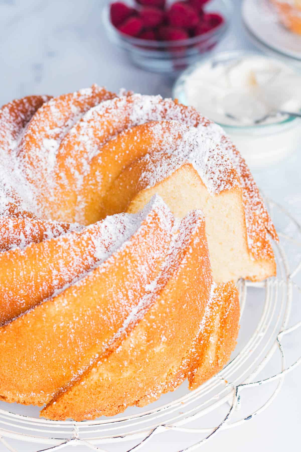 Whole old fashioned pound cake with a slice taken out. 