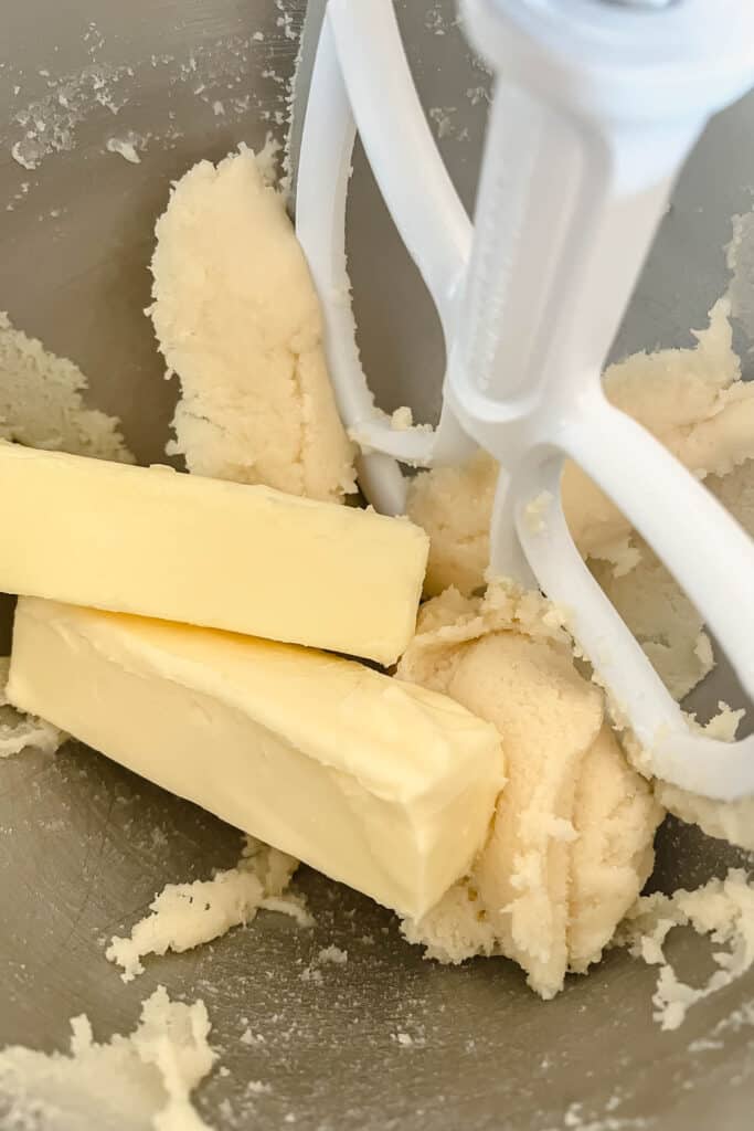 Adding more butter to the batter. 