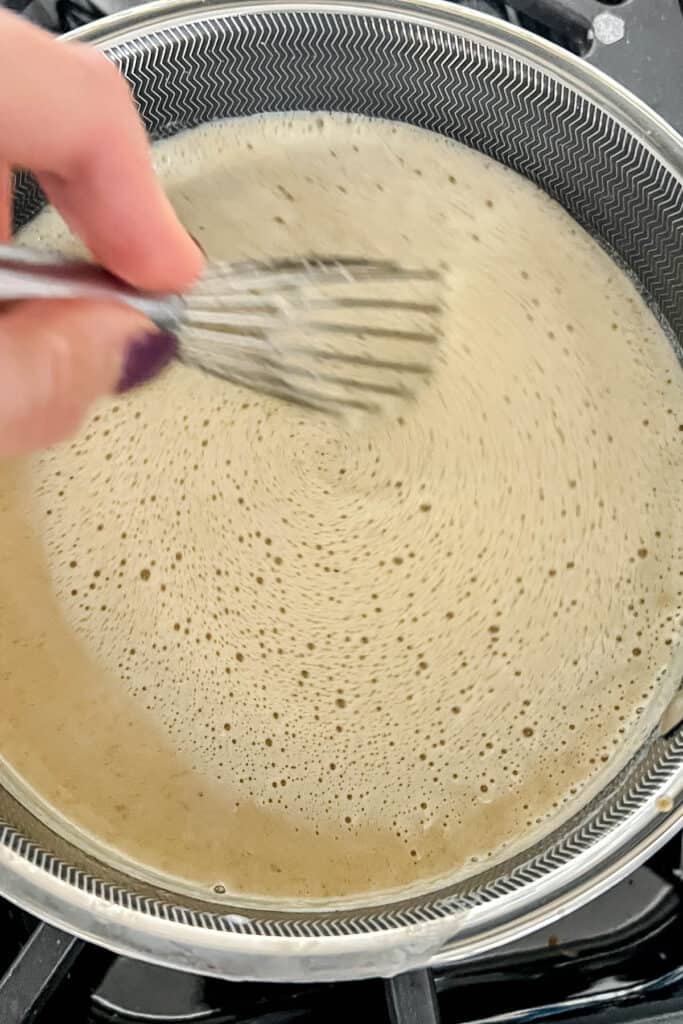 Whisking the gingerbread creme brûlée custard over low heat. 