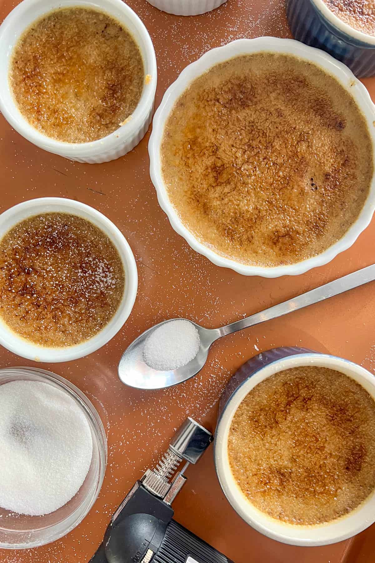 Finished gingerbread creme brûlées on a baking sheet. 