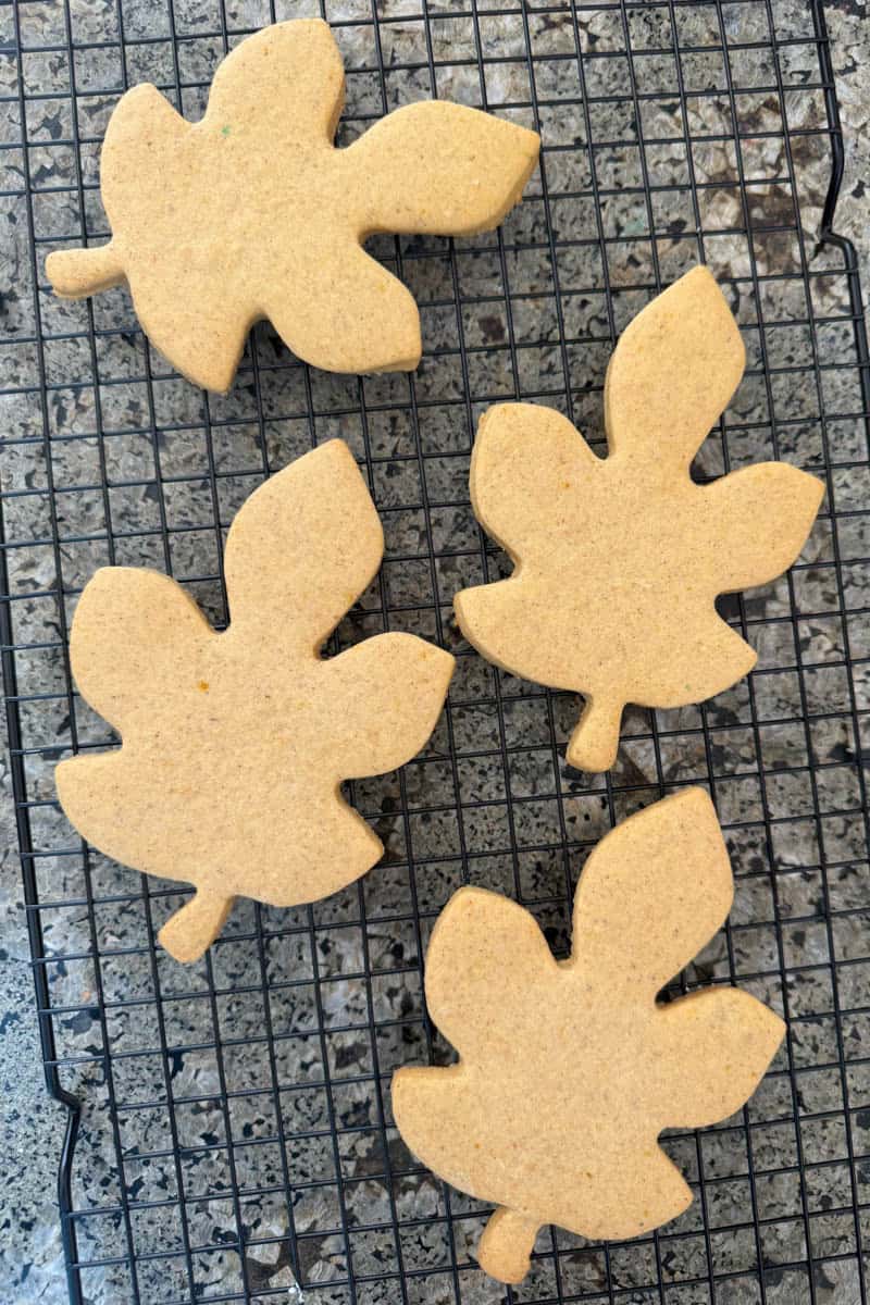 Baked pumpkin sugar cookies shaped like leaves. 